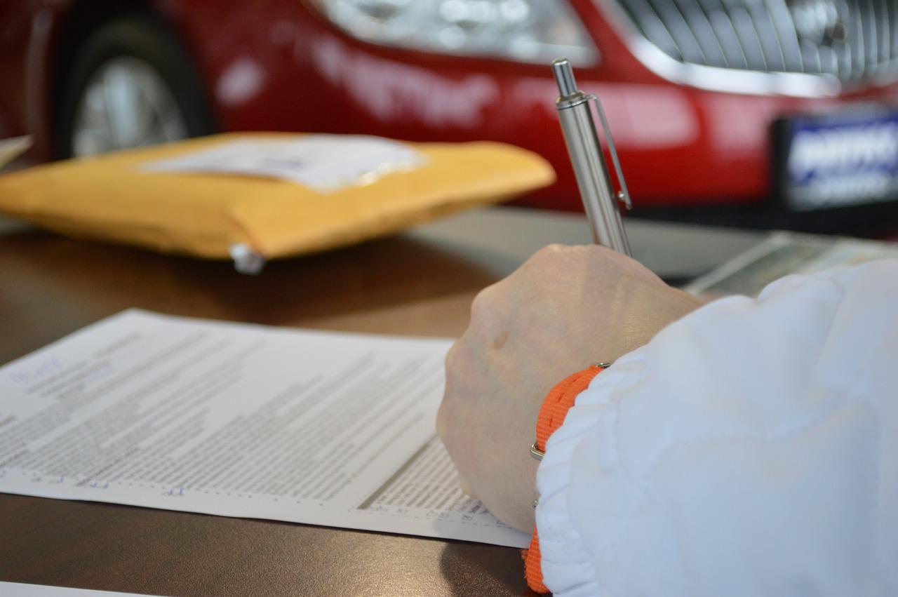 Hand writing on paper, signing document